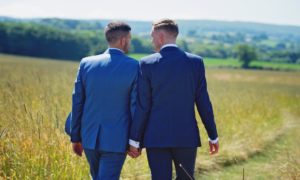 Civil Partnership and changing your name. Gay men walking in field