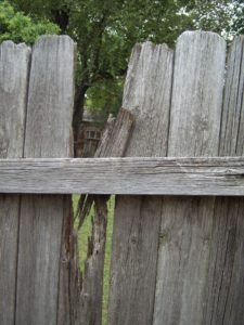 Fence Boundary Disputes Solicitors. Photo of broken wood fencing