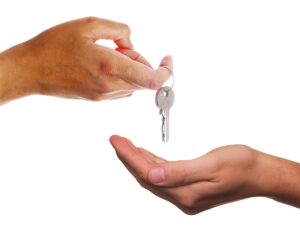 Transfer of Equity Solicitors. Specialist Property Conveyancing Lawyers. Photo of hands giving keys