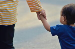 Private Adoption Lawyers. Specialist solicitors. Legal Advice on family & step parent adoptions. photo of toddler holding adult's hand